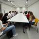Students sitting in a teaching room facing away from camera with guest speaker.