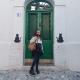 Student standing in front of green door