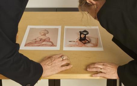 Photo of Professor Catriona Seth and Dr Marie-Eve Celio studying details of Liotard's portraits