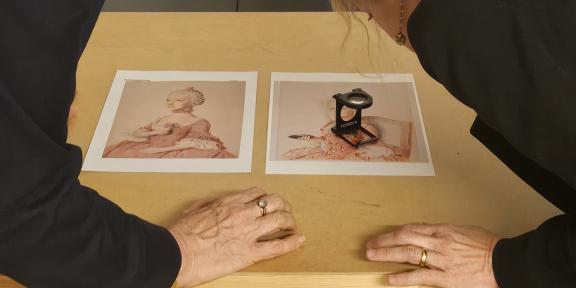 Photo of Professor Catriona Seth and Dr Marie-Eve Celio studying details of Liotard's portraits