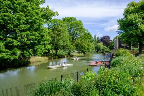 People punting on the River Cherwell, St Hilda's College