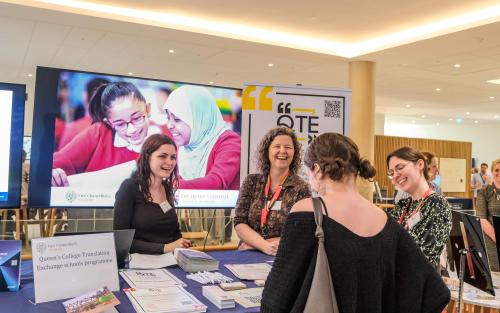 Dr Charlotte Ryland, Dr Elly Walters, and a student ambassador talking to someone at their stall at the Vice Chancellor's awards.