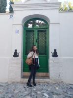 Student standing in front of green door