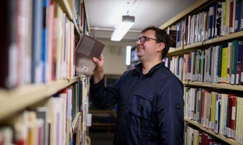 A graduate student looking for books in the stacks of the Taylor Institution Library