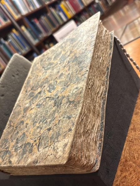 Photo of a closed book in a library setting