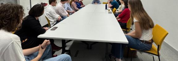 Students sitting in a teaching room facing away from camera with guest speaker.