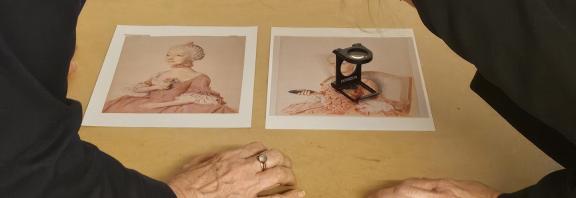 Photo of Professor Catriona Seth and Dr Marie-Eve Celio studying details of Liotard's portraits