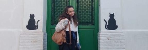 Student standing in front of green door